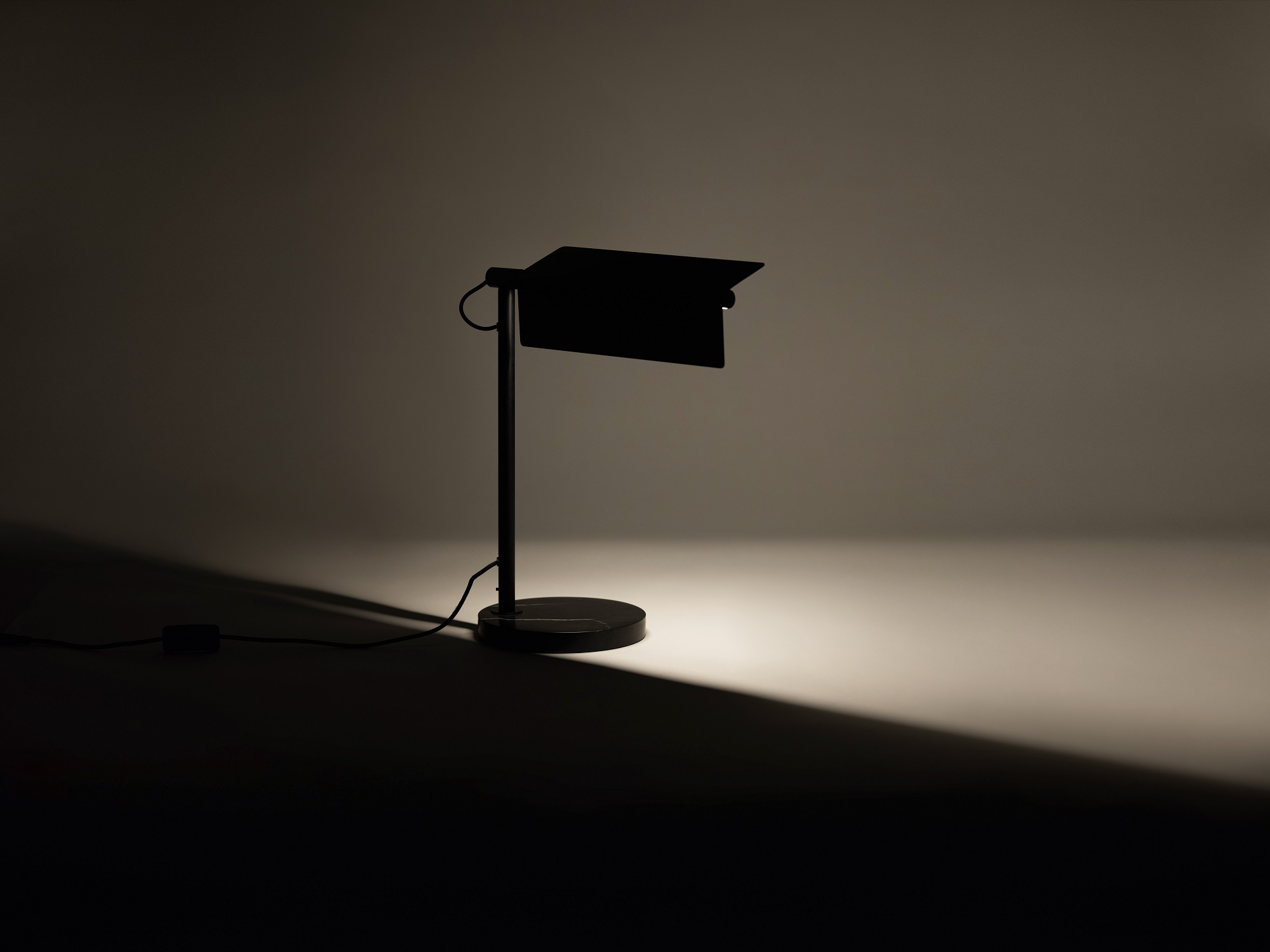 The Oxford side table lamp with light on and shade angled